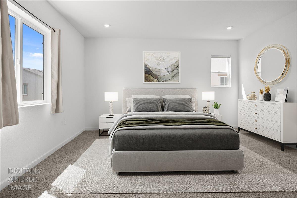 18462 Waterfront Way Lathrop, CA 95330 - Photo 24 of 50 a bedroom with a large bed and a chandelier