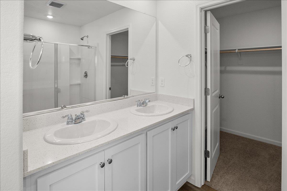 18462 Waterfront Way Lathrop, CA 95330 - Photo 29 of 50 a bathroom with a sink double vanity and shower