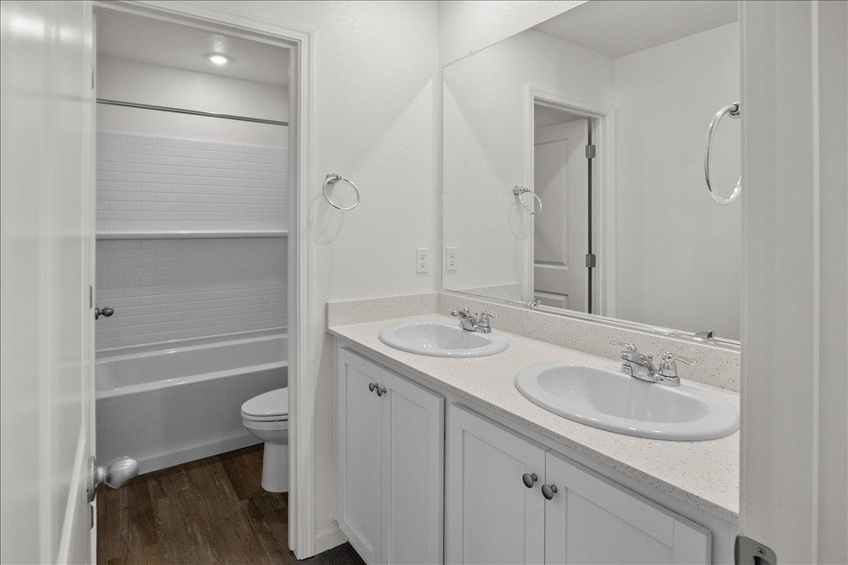 18462 Waterfront Way Lathrop, CA 95330 - Photo 37 of 50 a bathroom with a sink toilet a tub and shower