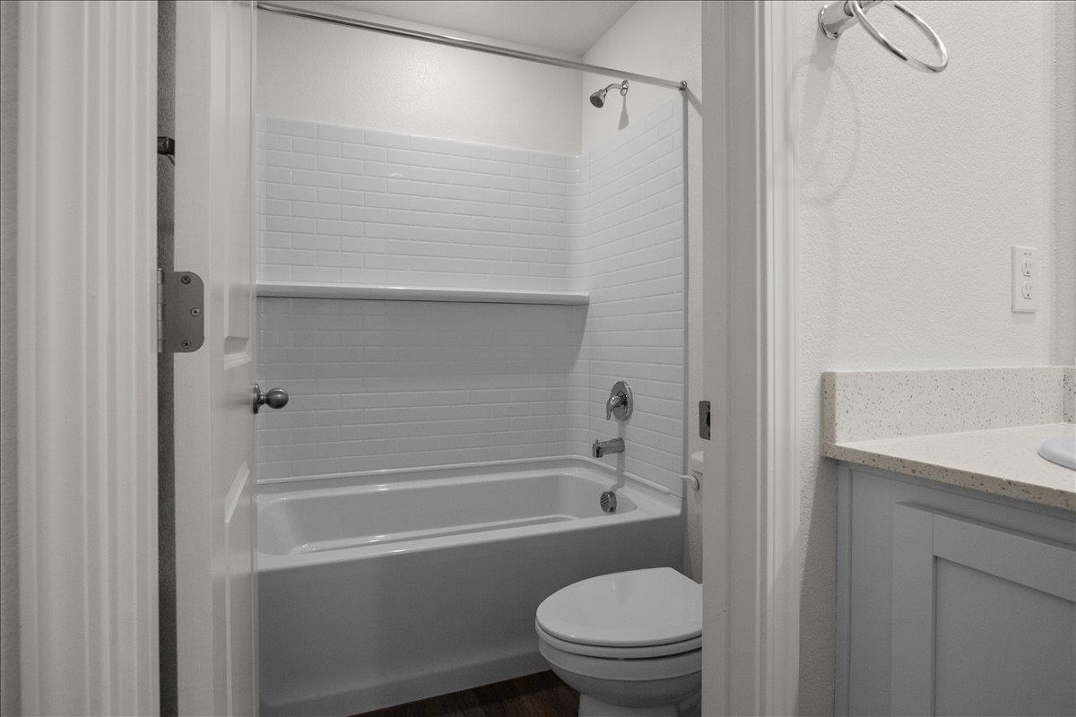 18462 Waterfront Way Lathrop, CA 95330 - Photo 38 of 50 a bathroom with a granite countertop bathtub shower sink vanity and toilet