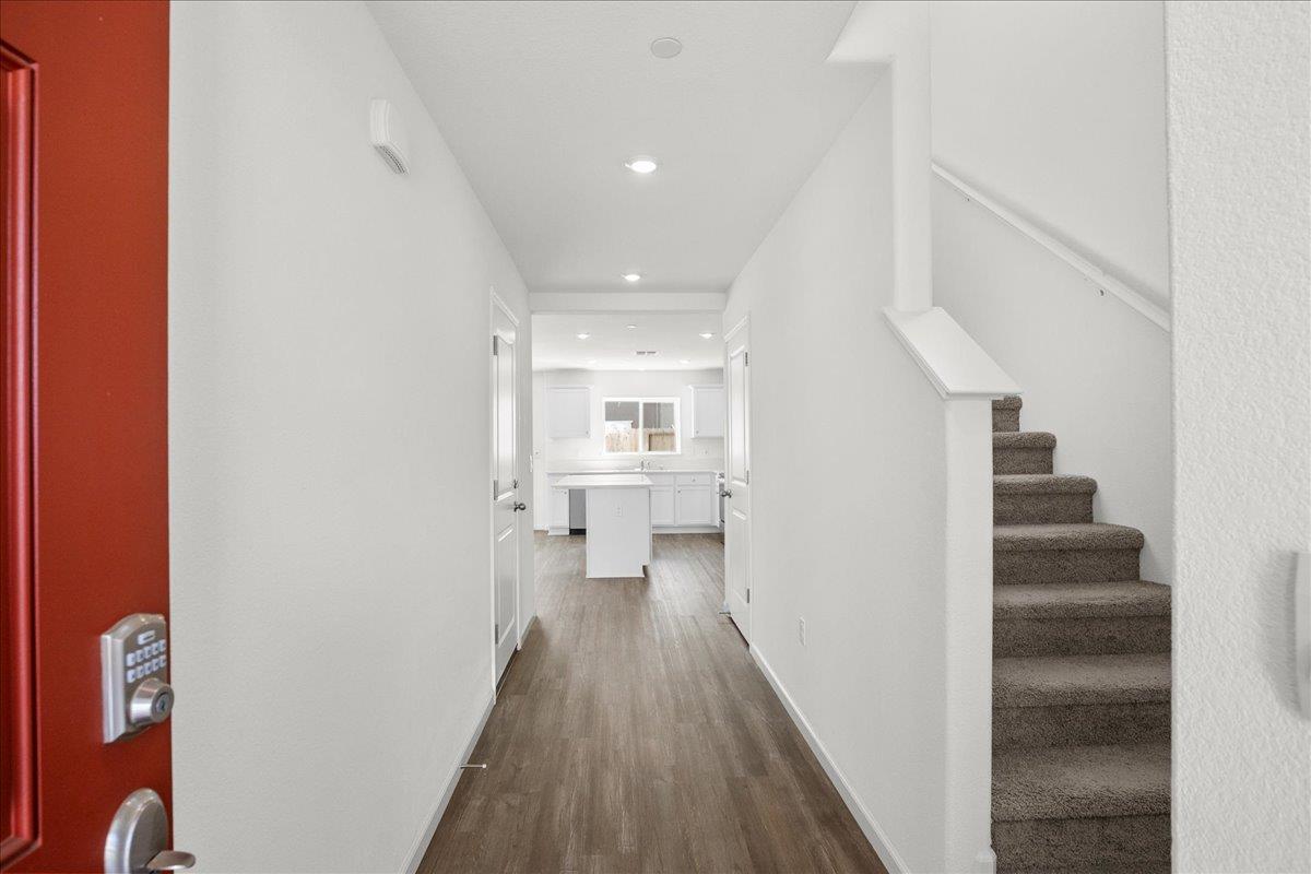 18462 Waterfront Way Lathrop, CA 95330 - Photo 4 of 50 a view of a hallway with wooden floor and staircase
