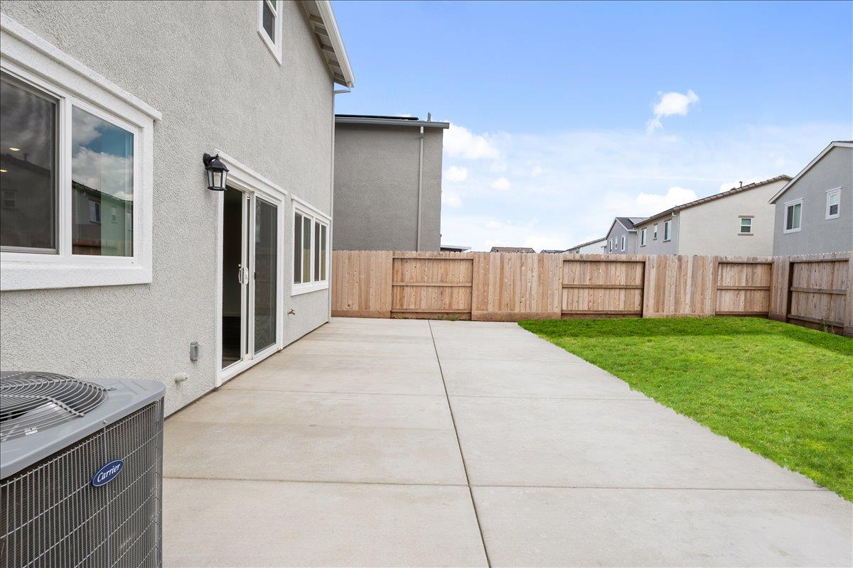 18462 Waterfront Way Lathrop, CA 95330 - Photo 50 of 50 a view of backyard with barbeque grill potted plants and wooden fence