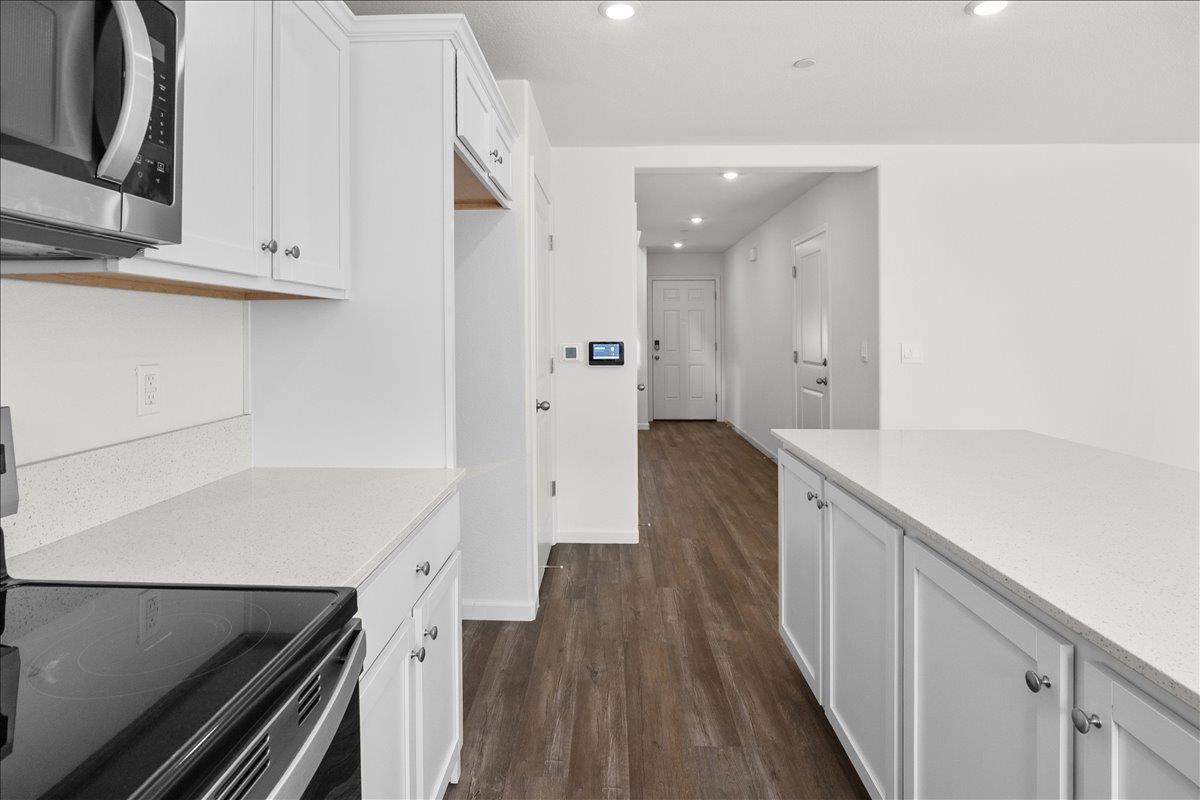 18462 Waterfront Way Lathrop, CA 95330 - Photo 10 of 50 a kitchen with cabinets and wooden floor
