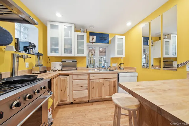 a kitchen with stainless steel appliances granite countertop a stove and a sink