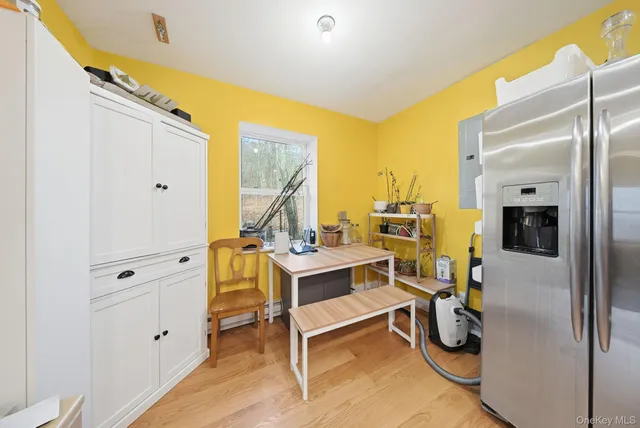 a view of a workspace with furniture and a window