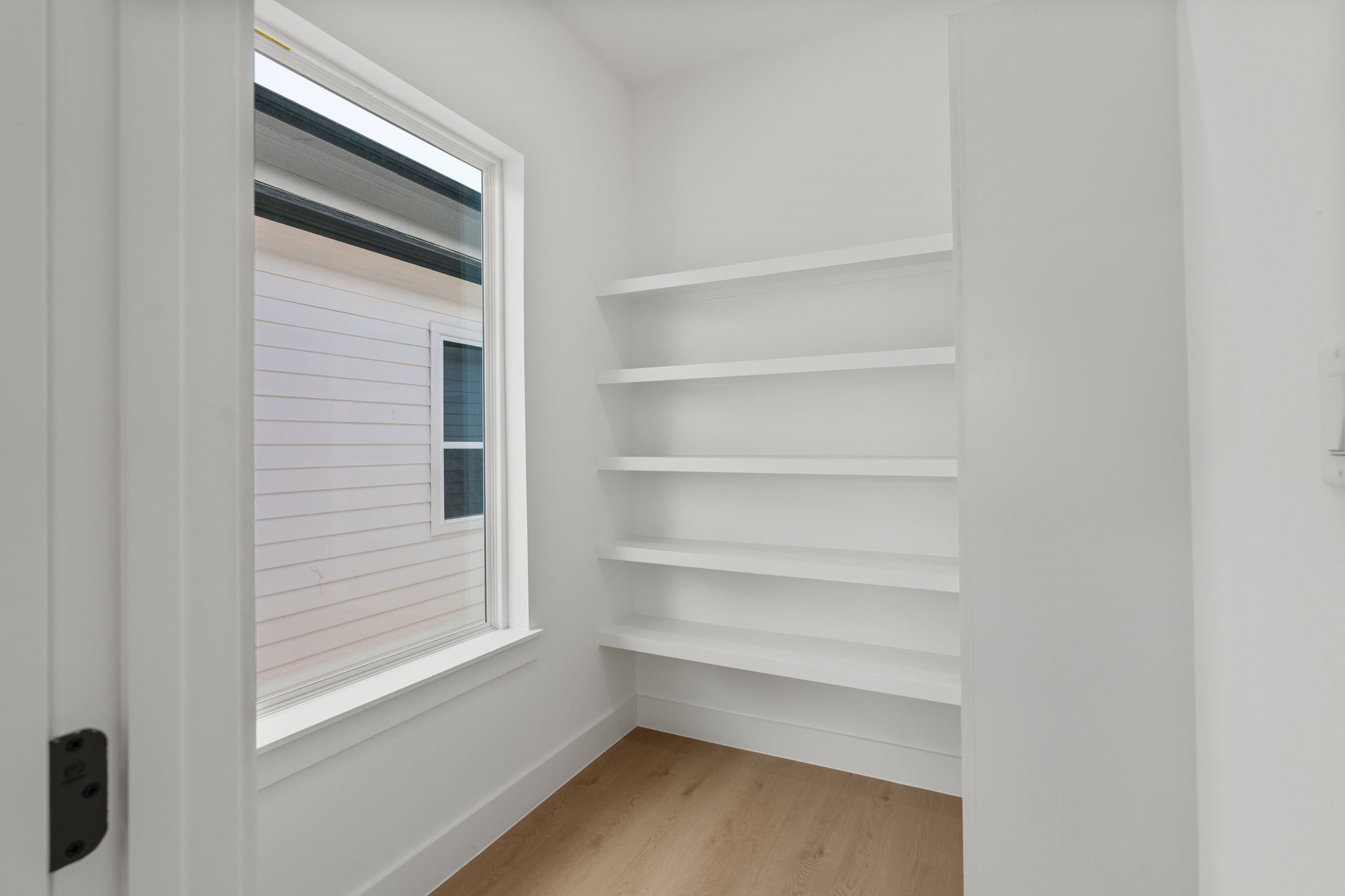 7321 Laura Koppe Road Houston, TX 77028 - Photo 11 of 41 Bright and airy storage space featuring built-in shelves and a large window for natural light.