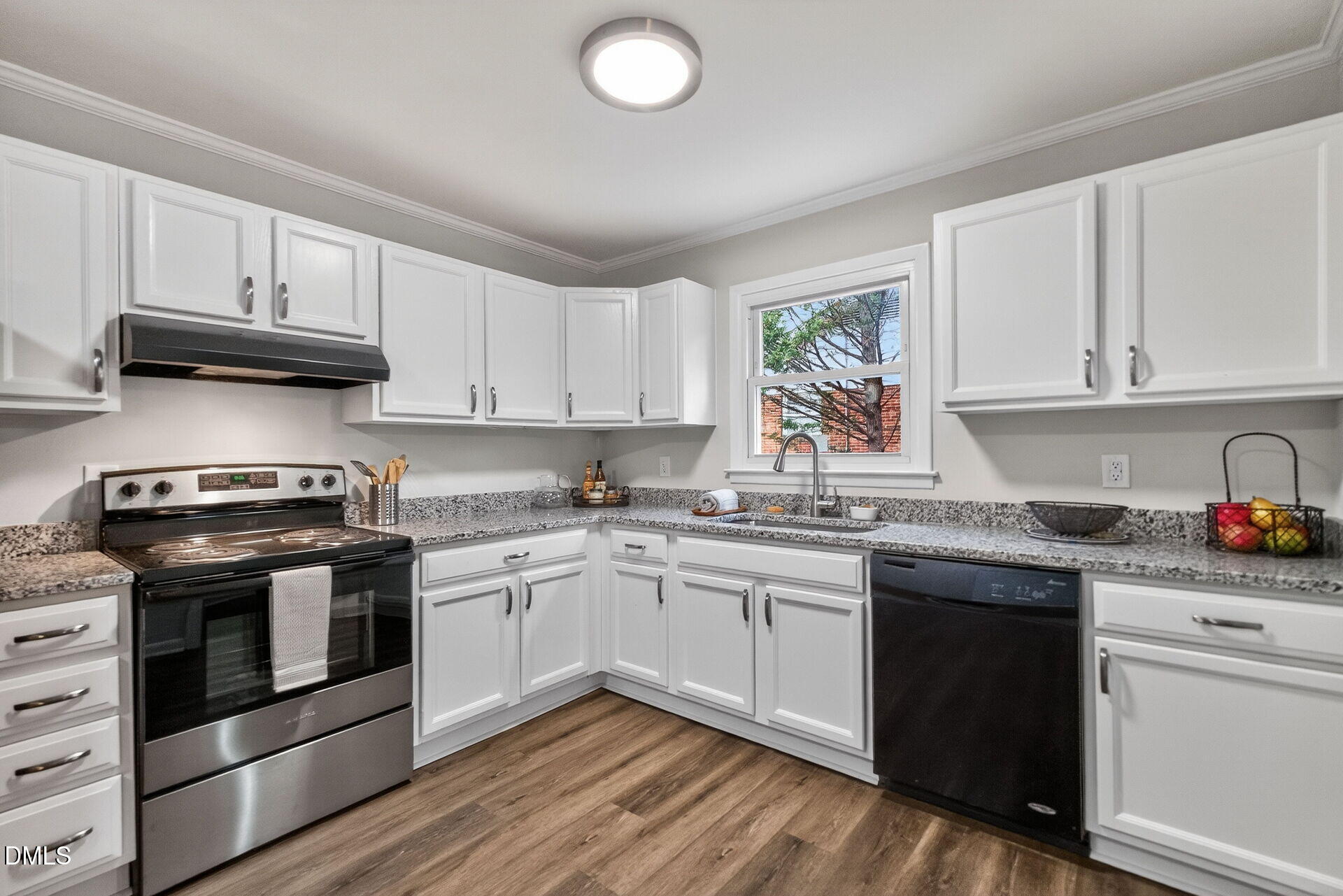 517 Cooper Road Raleigh, NC 27610 - Photo 10 of 29 a kitchen with a stove sink and cabinets