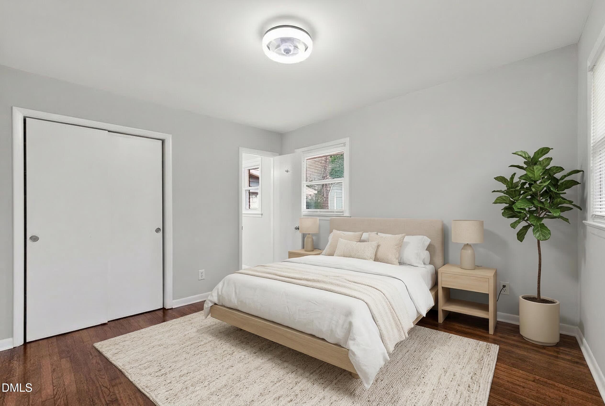 517 Cooper Road Raleigh, NC 27610 - Photo 16 of 29 a bedroom with a bed and a potted plant