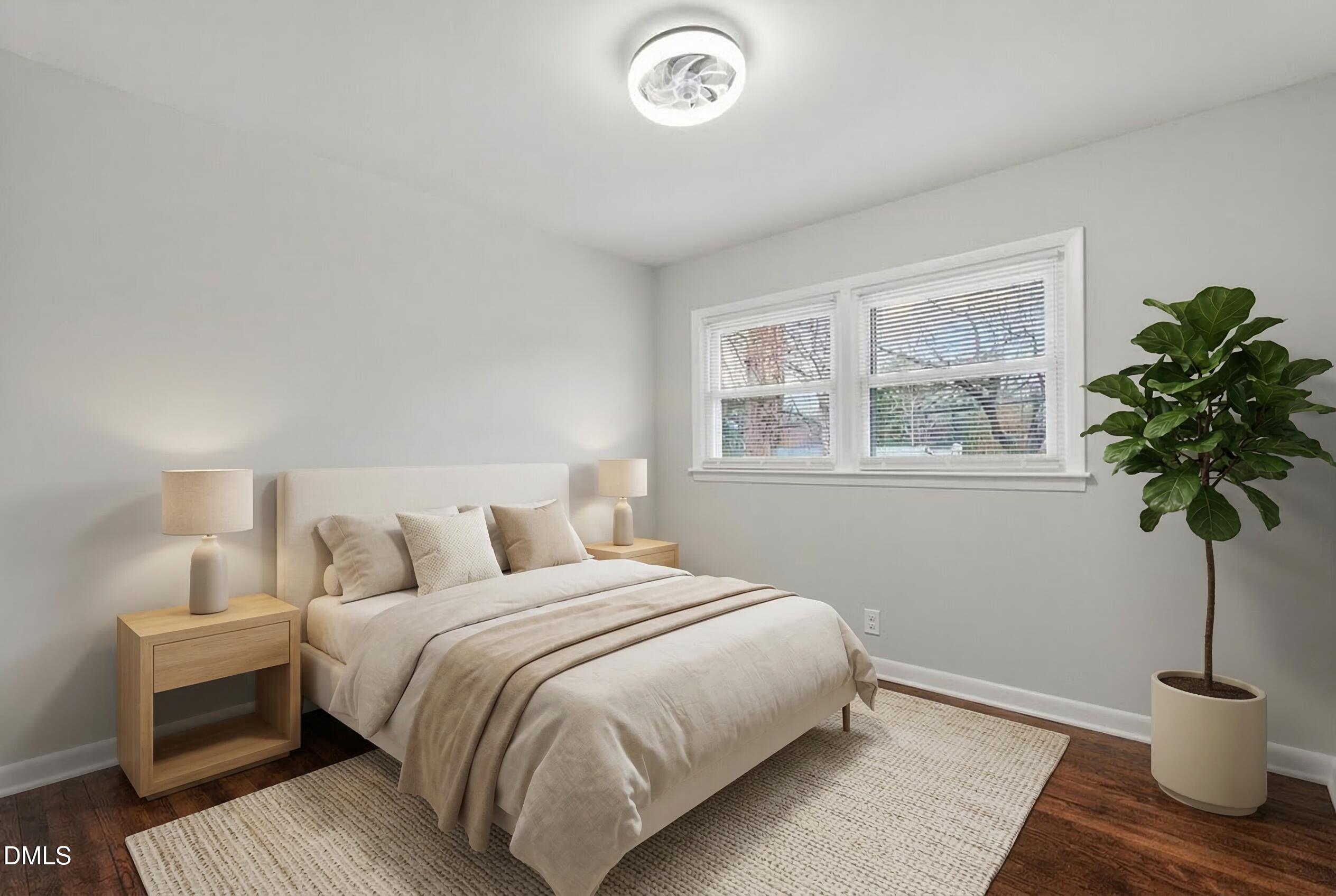 517 Cooper Road Raleigh, NC 27610 - Photo 21 of 29 a bedroom with a bed and a potted plant