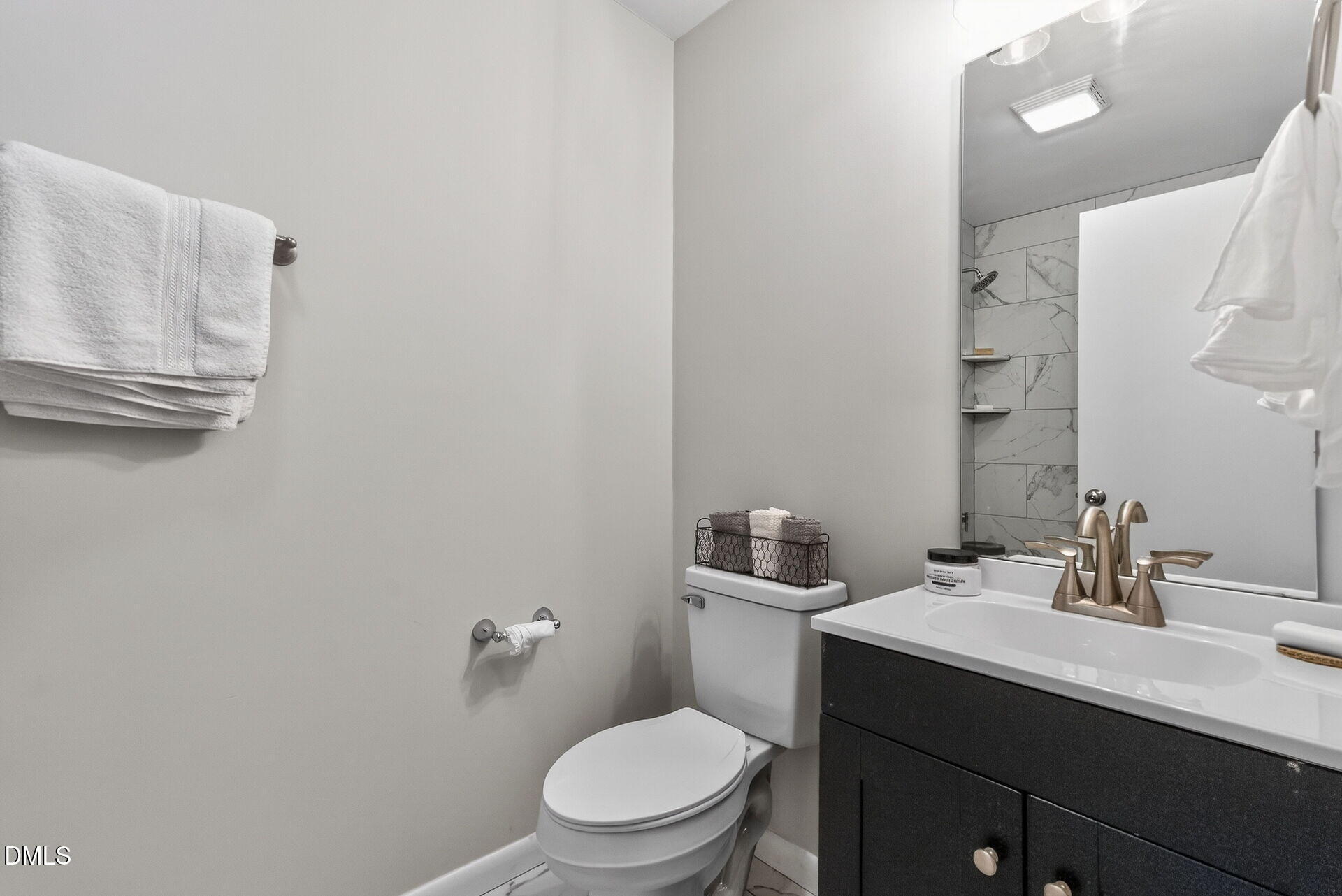 517 Cooper Road Raleigh, NC 27610 - Photo 23 of 29 a bathroom with a toilet a sink and mirror