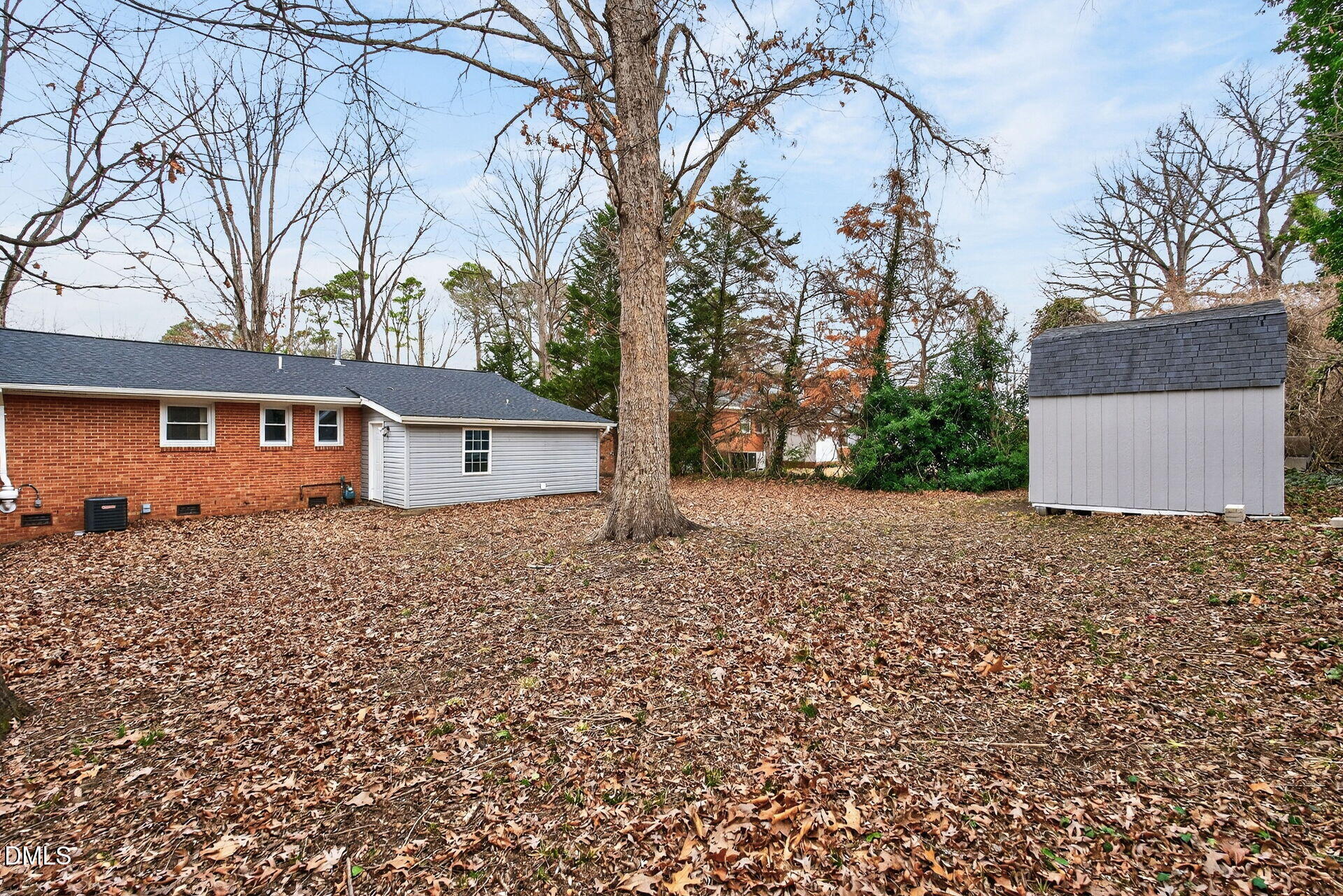 517 Cooper Road Raleigh, NC 27610 - Photo 26 of 29 a backyard of a house with large trees and wooden fence