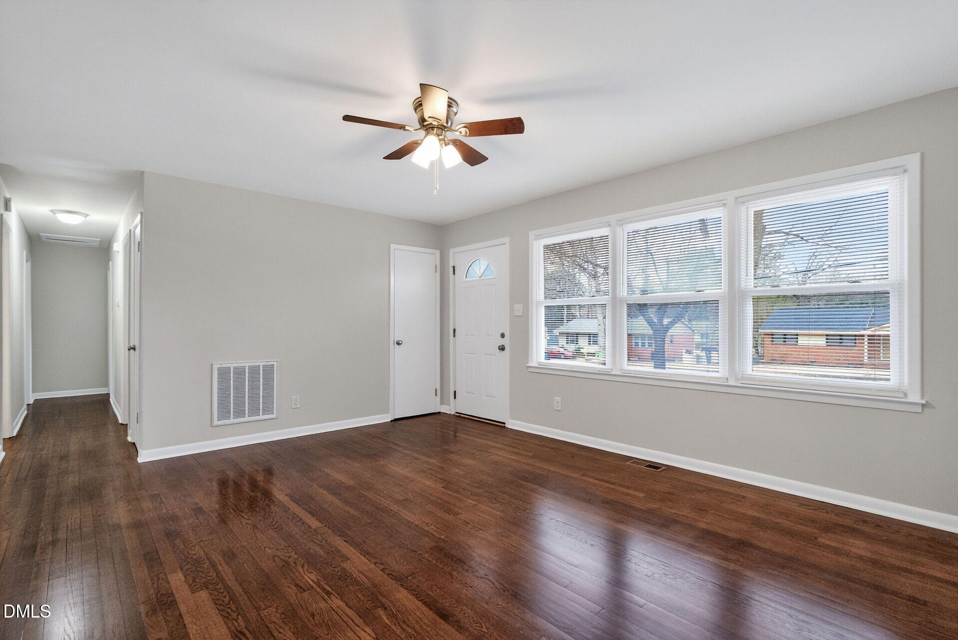 517 Cooper Road Raleigh, NC 27610 - Photo 7 of 29 a view of an empty room with wooden floor and a window