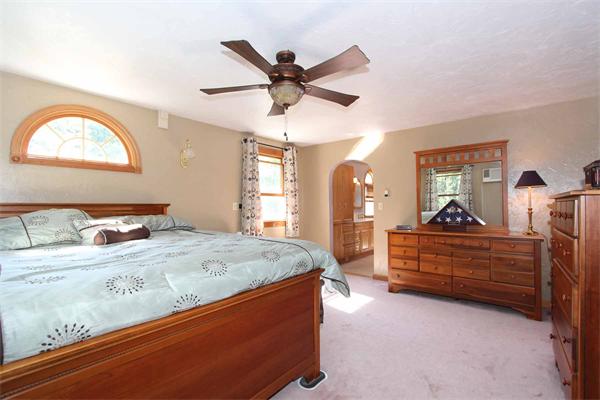 160 Middle Road Southborough, MA 01772 - Photo 13 of 28 a bed room with a bed and a chandelier