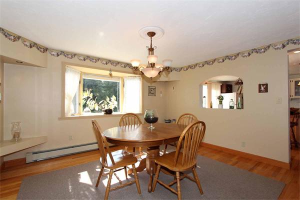 160 Middle Road Southborough, MA 01772 - Photo 7 of 28 a dining room with furniture a chandelier and wooden floor
