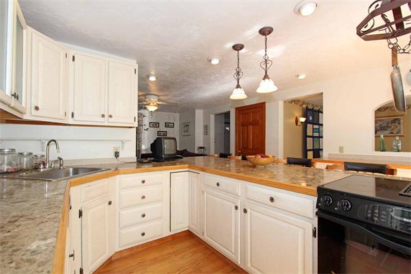 160 Middle Road Southborough, MA 01772 - Photo 9 of 28 a kitchen with a sink dishwasher and white cabinets with wooden floor