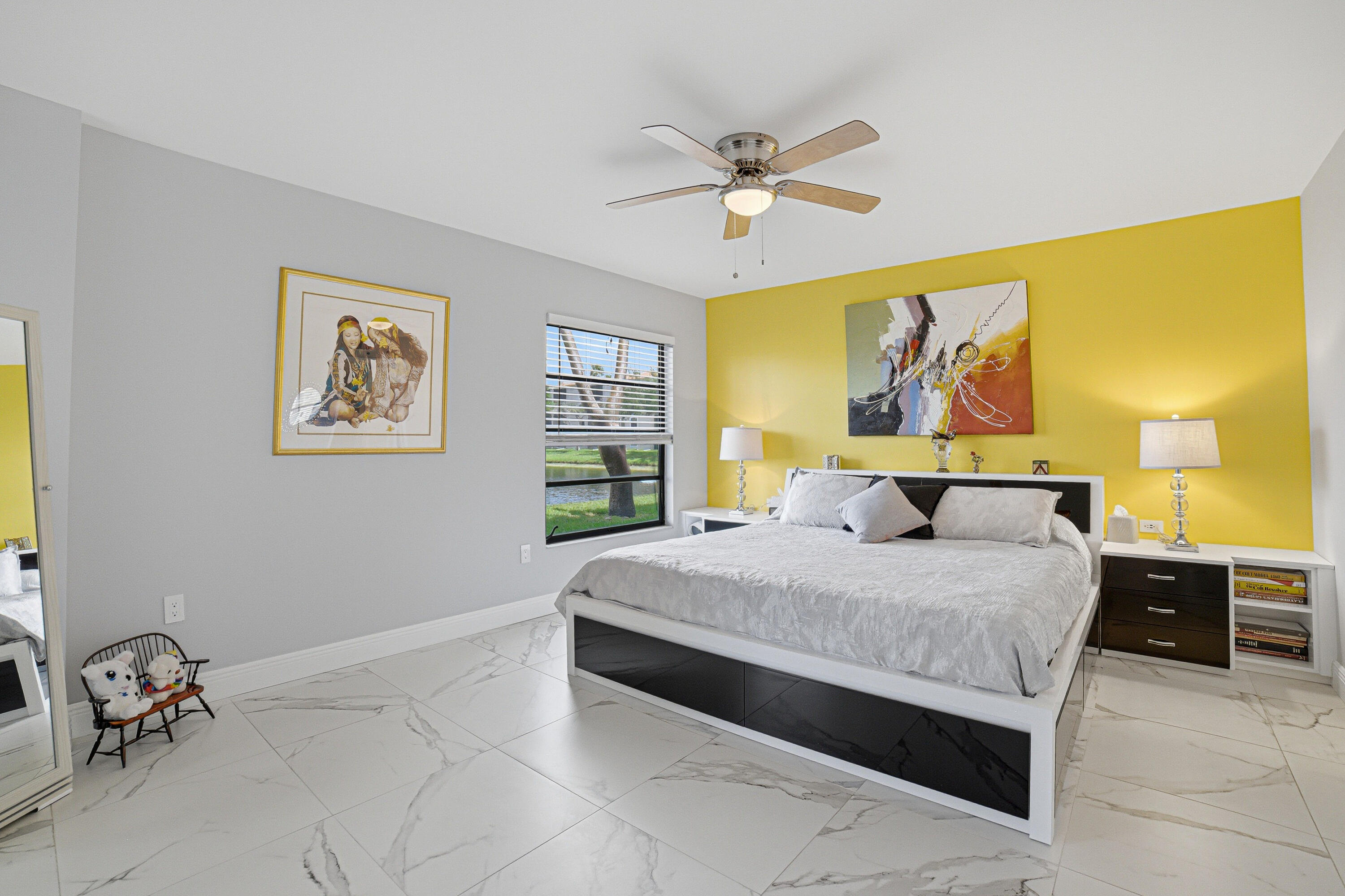6149 Pointe Regal Circle, Unit 104 Delray Beach, FL 33484 - Photo 18 of 64 a bedroom with a bed and painting on the wall