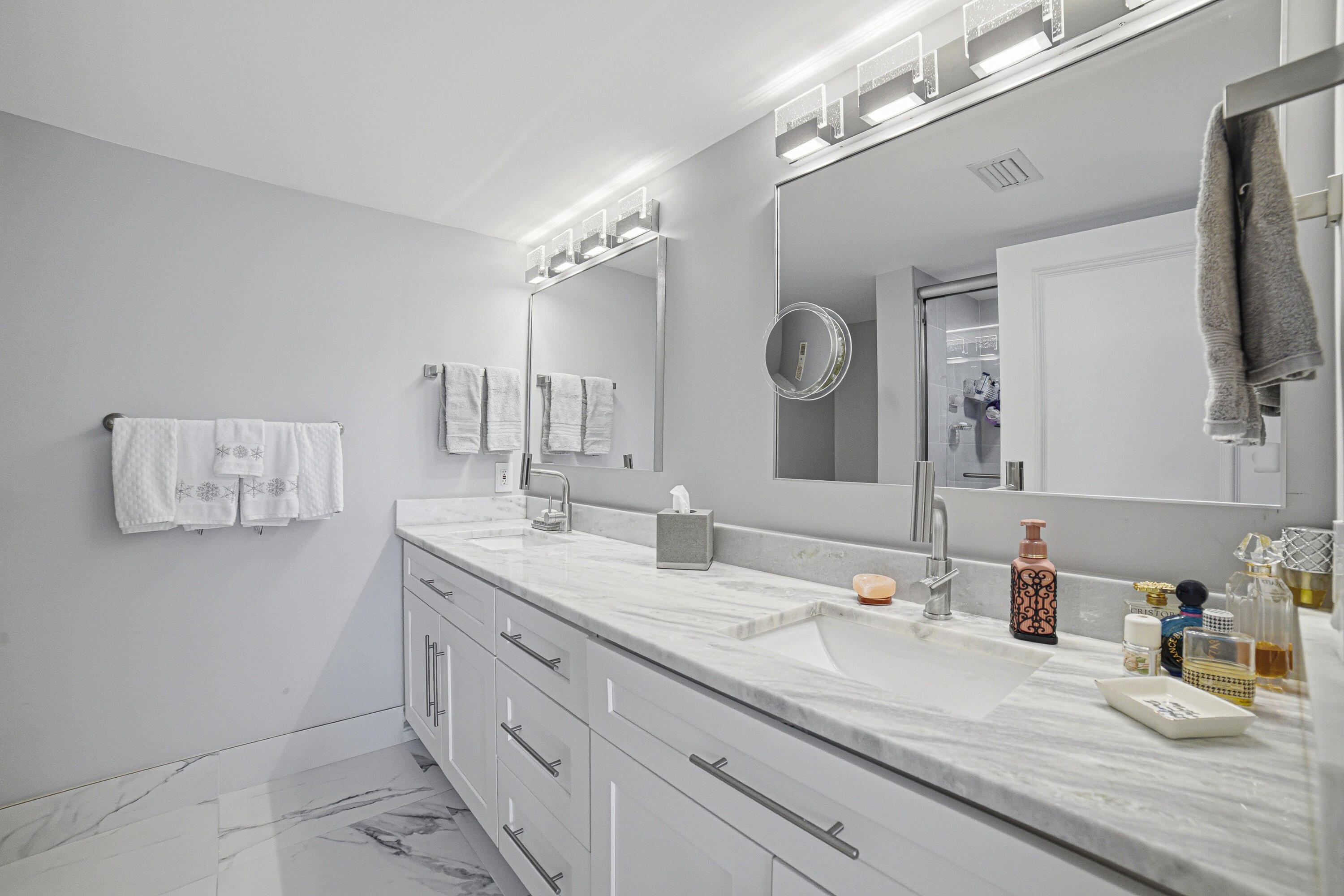 6149 Pointe Regal Circle, Unit 104 Delray Beach, FL 33484 - Photo 23 of 64 a bathroom with a double vanity sink and a mirror