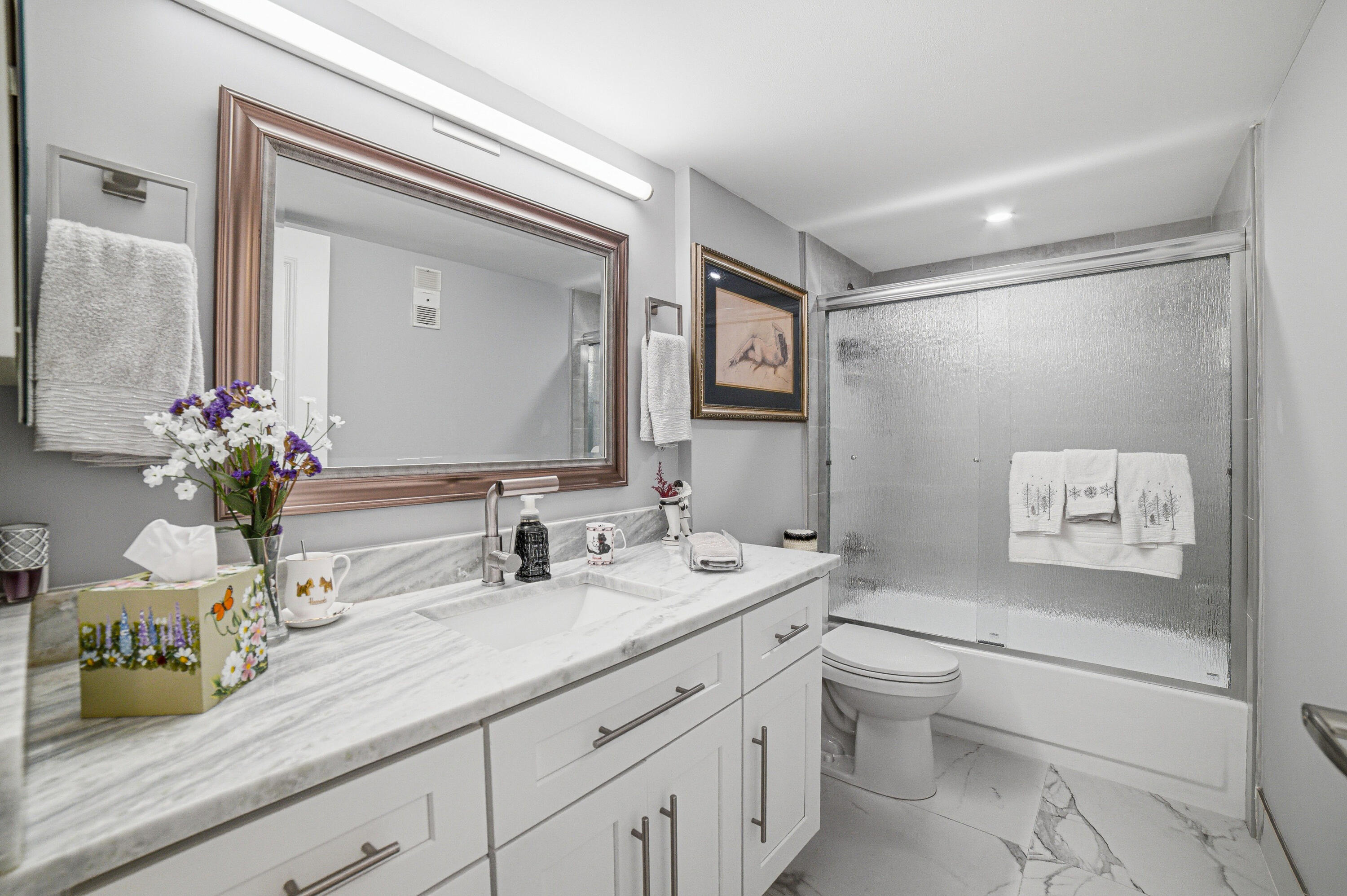 6149 Pointe Regal Circle, Unit 104 Delray Beach, FL 33484 - Photo 28 of 64 a bathroom with a granite countertop sink mirror vanity and toilet