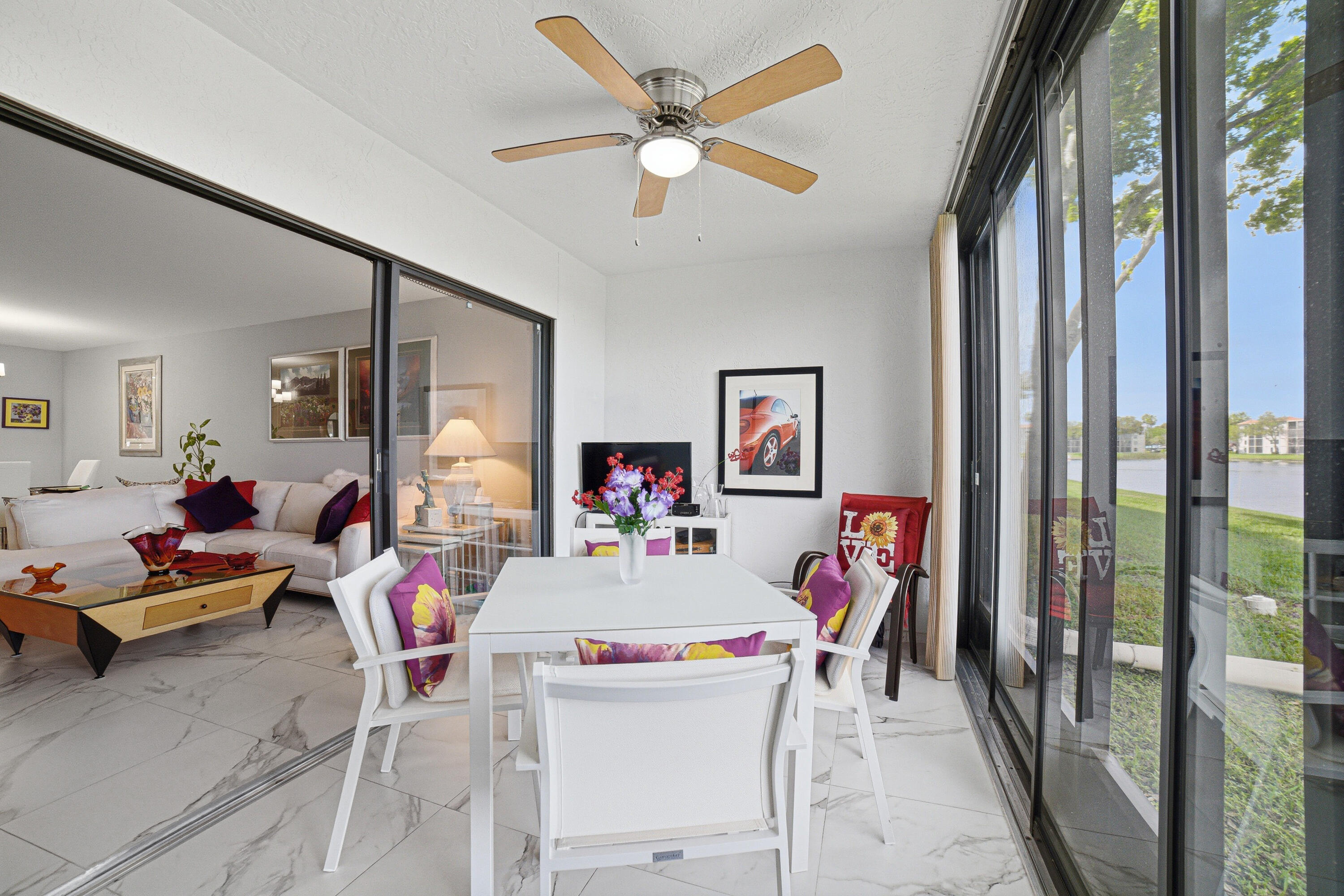 6149 Pointe Regal Circle, Unit 104 Delray Beach, FL 33484 - Photo 30 of 64 a living room with furniture and a large window with garden view