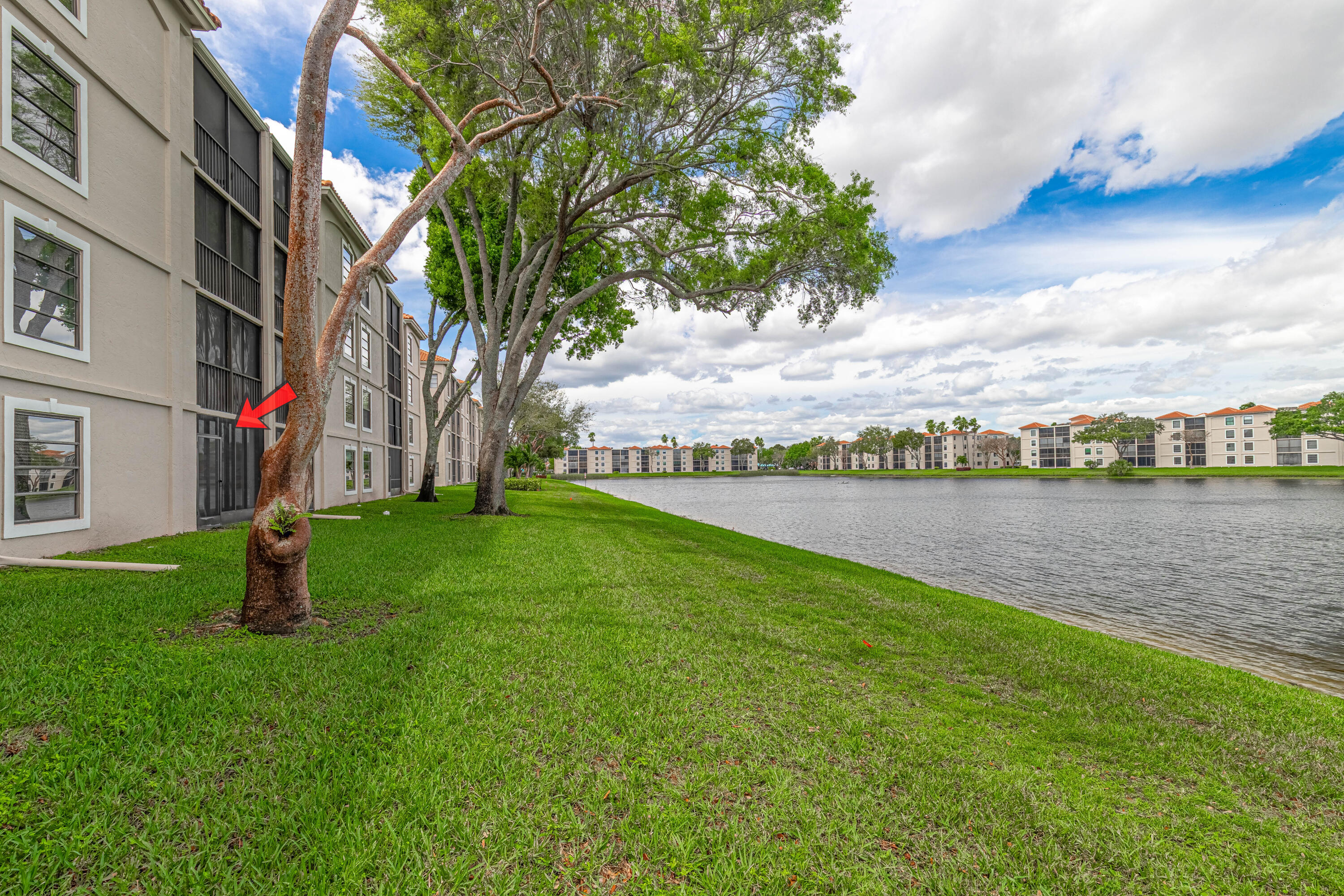 6149 Pointe Regal Circle, Unit 104 Delray Beach, FL 33484 - Photo 33 of 64 a view of a lake with a big yard