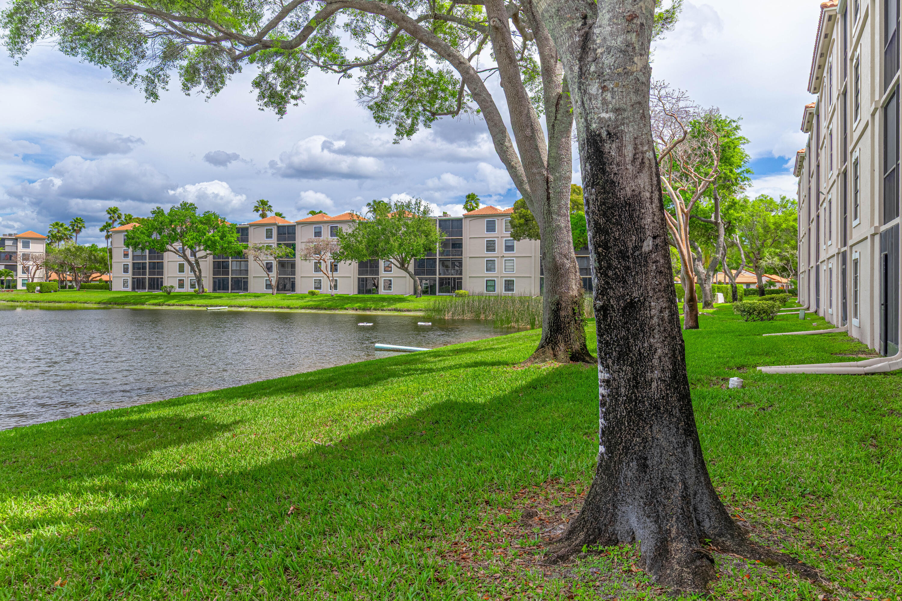 6149 Pointe Regal Circle, Unit 104 Delray Beach, FL 33484 - Photo 34 of 64 a view of a garden with a lake view