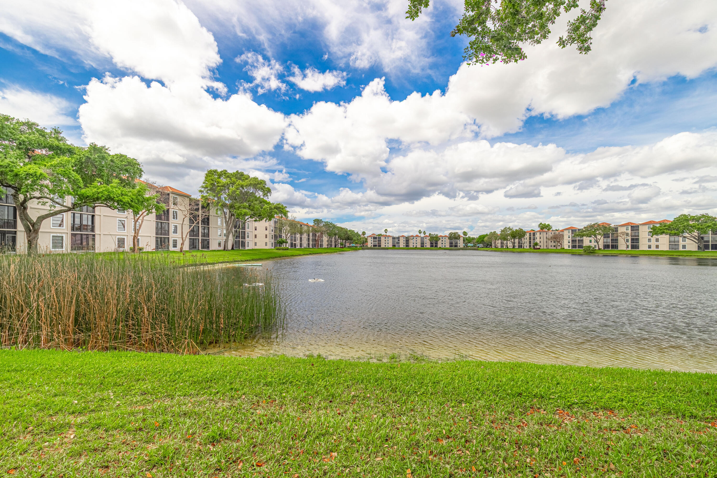 6149 Pointe Regal Circle, Unit 104 Delray Beach, FL 33484 - Photo 36 of 64 a view of a lake from a yard