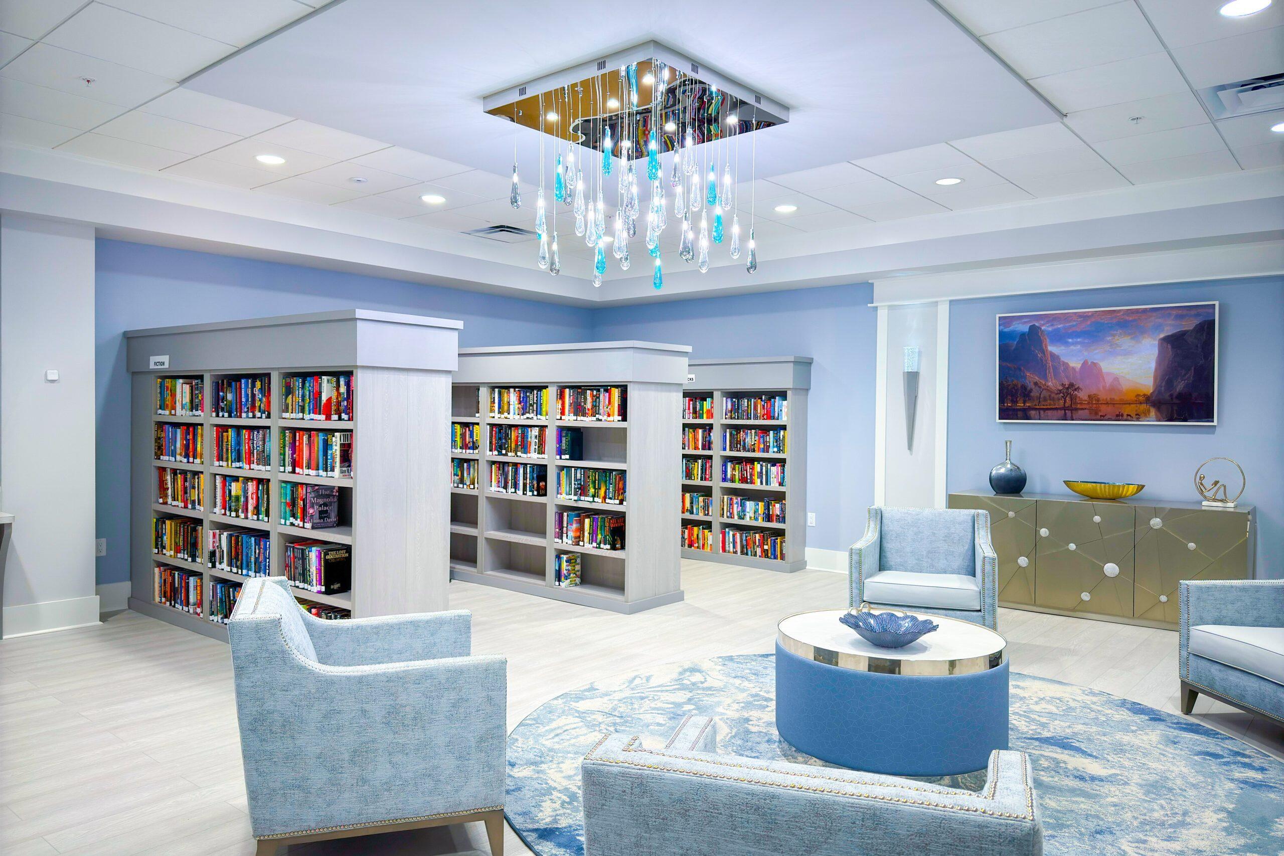 6149 Pointe Regal Circle, Unit 104 Delray Beach, FL 33484 - Photo 46 of 64 a living room with couches and a bookshelf
