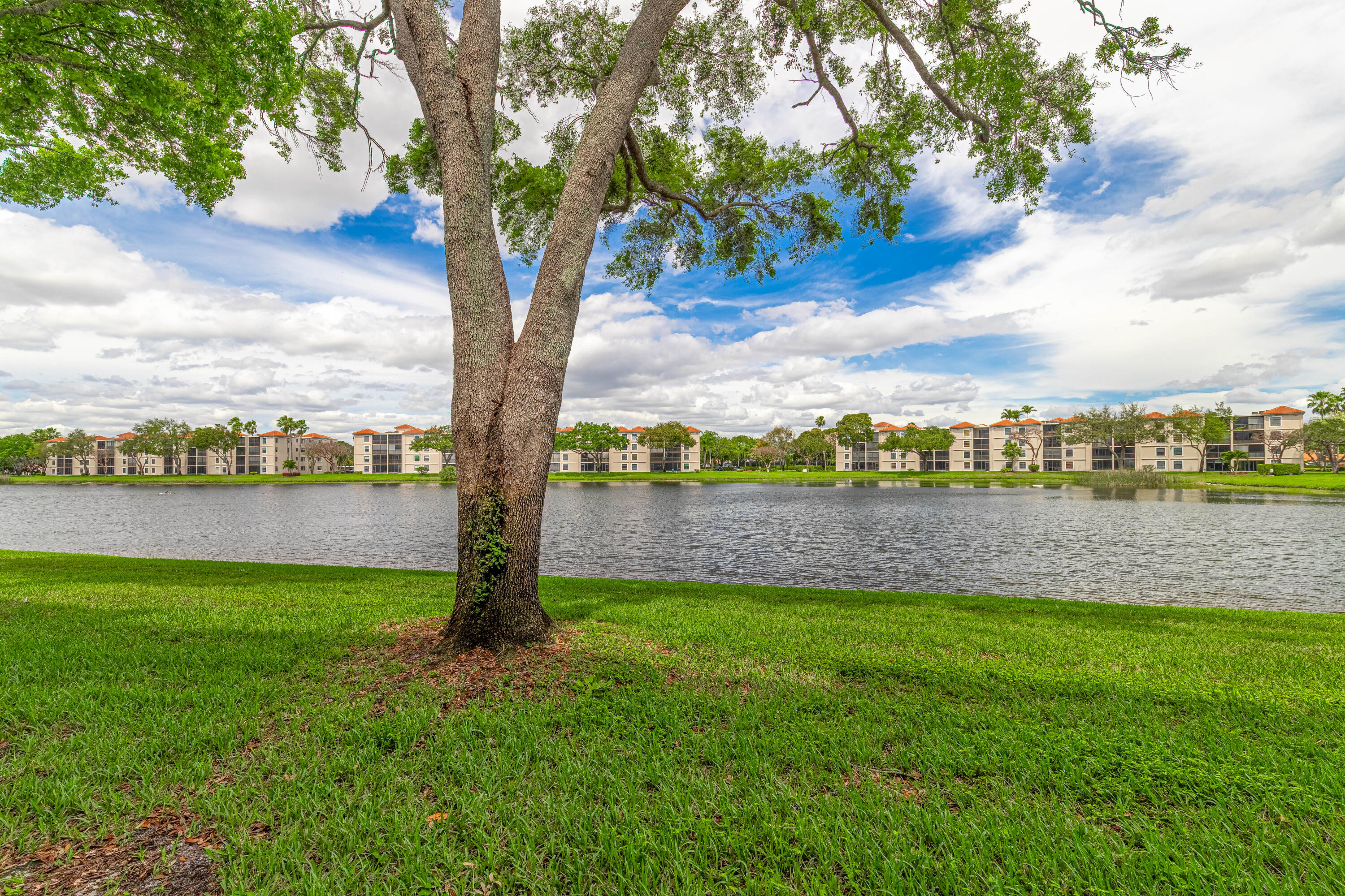 6149 Pointe Regal Circle, Unit 104 Delray Beach, FL 33484 - Photo 5 of 64 a view of a lake with a big yard