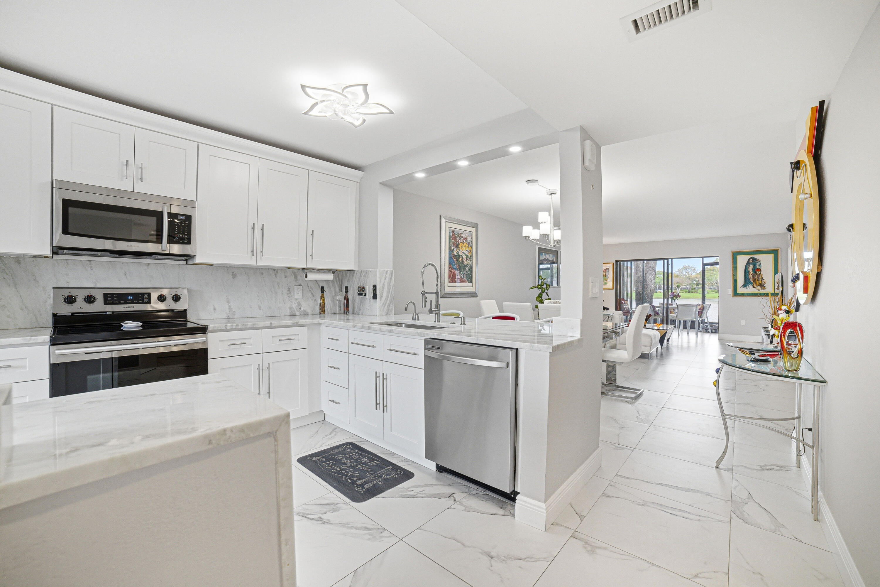 6149 Pointe Regal Circle, Unit 104 Delray Beach, FL 33484 - Photo 6 of 64 a kitchen with appliances cabinets and a sink