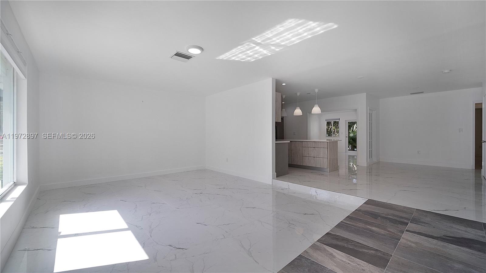 11690 Southwest 81st Road, Unit 11690 Pinecrest, FL 33156 - Photo 11 of 26 a view of a hallway with a chandelier fan