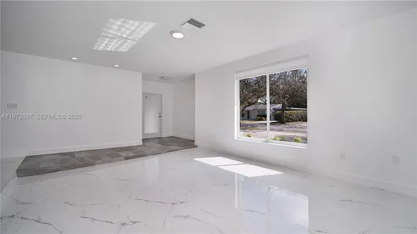 a view of an empty room with a window