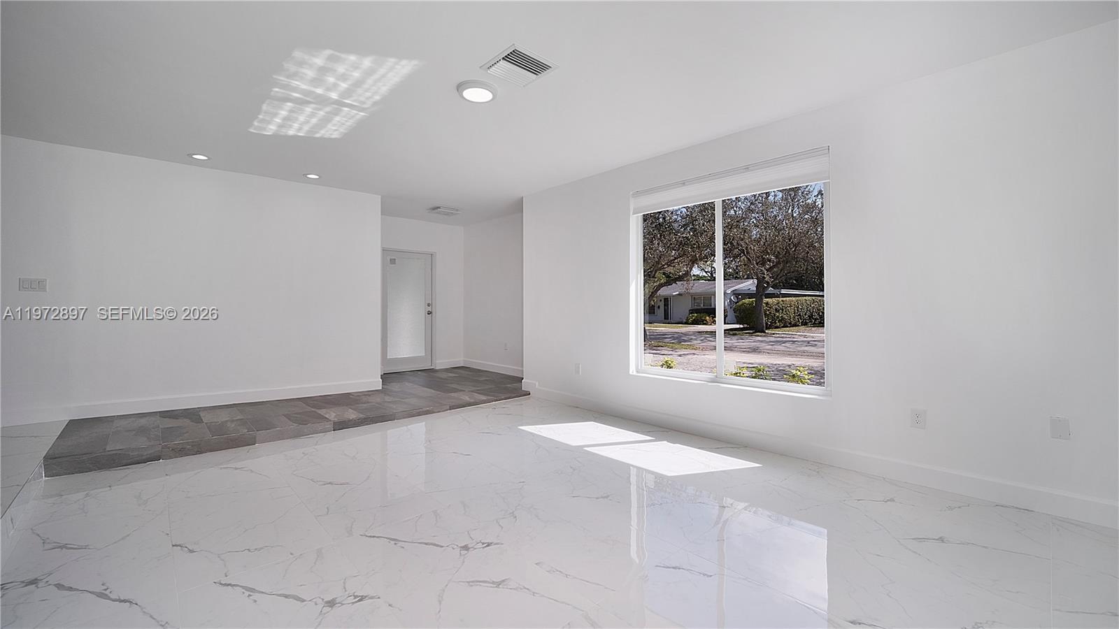 11690 Southwest 81st Road, Unit 11690 Pinecrest, FL 33156 - Photo 12 of 26 a view of an empty room with a window