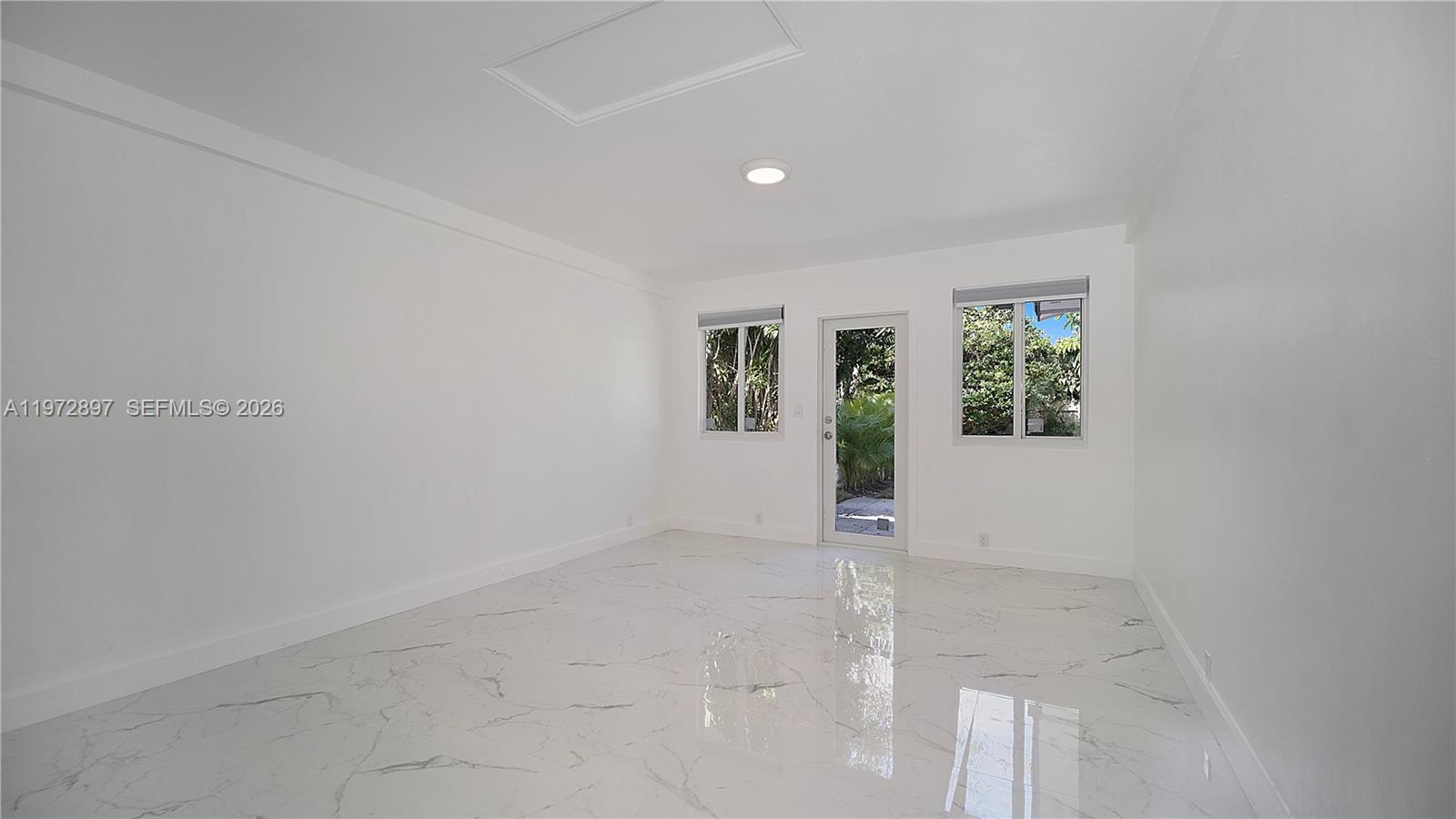 11690 Southwest 81st Road, Unit 11690 Pinecrest, FL 33156 - Photo 13 of 26 an empty room with windows