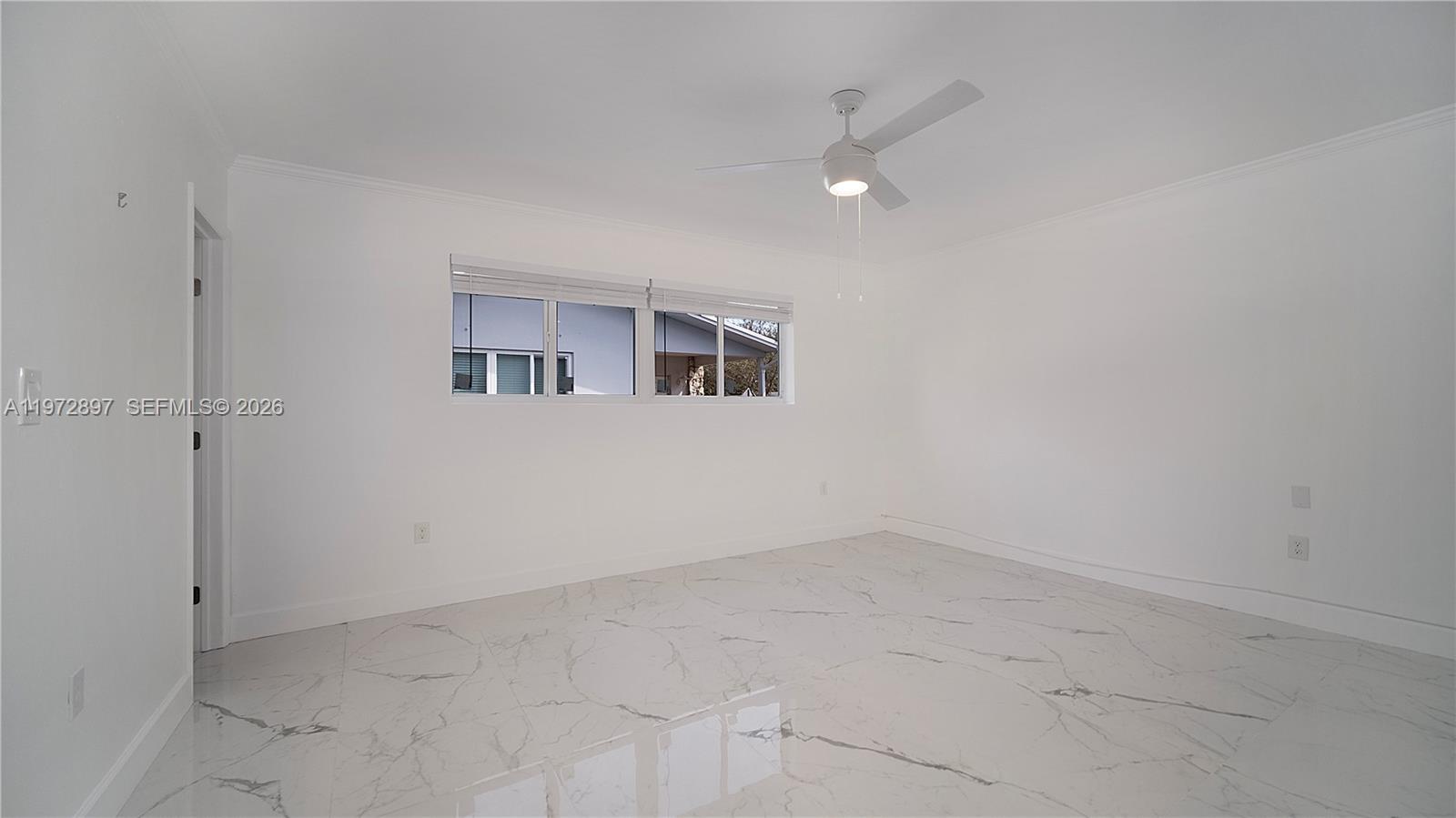 11690 Southwest 81st Road, Unit 11690 Pinecrest, FL 33156 - Photo 15 of 26 an empty room with a empty space and windows