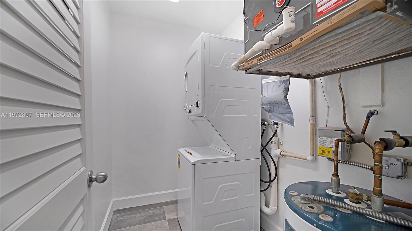 11690 Southwest 81st Road, Unit 11690 Pinecrest, FL 33156 - Photo 19 of 26 a room with gym equipment