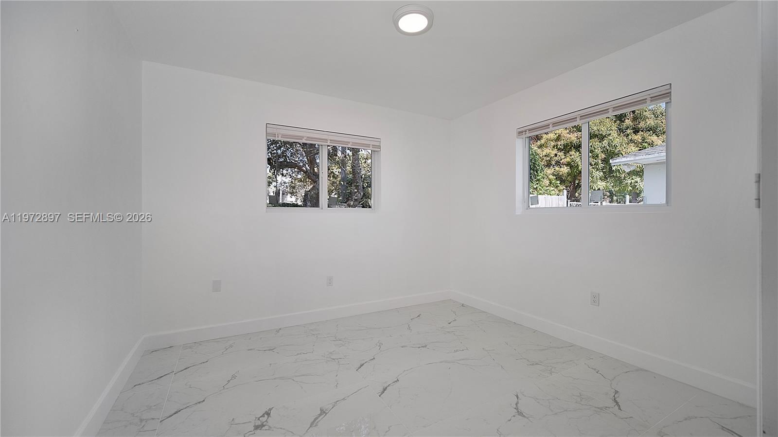 11690 Southwest 81st Road, Unit 11690 Pinecrest, FL 33156 - Photo 21 of 26 an empty room with a window