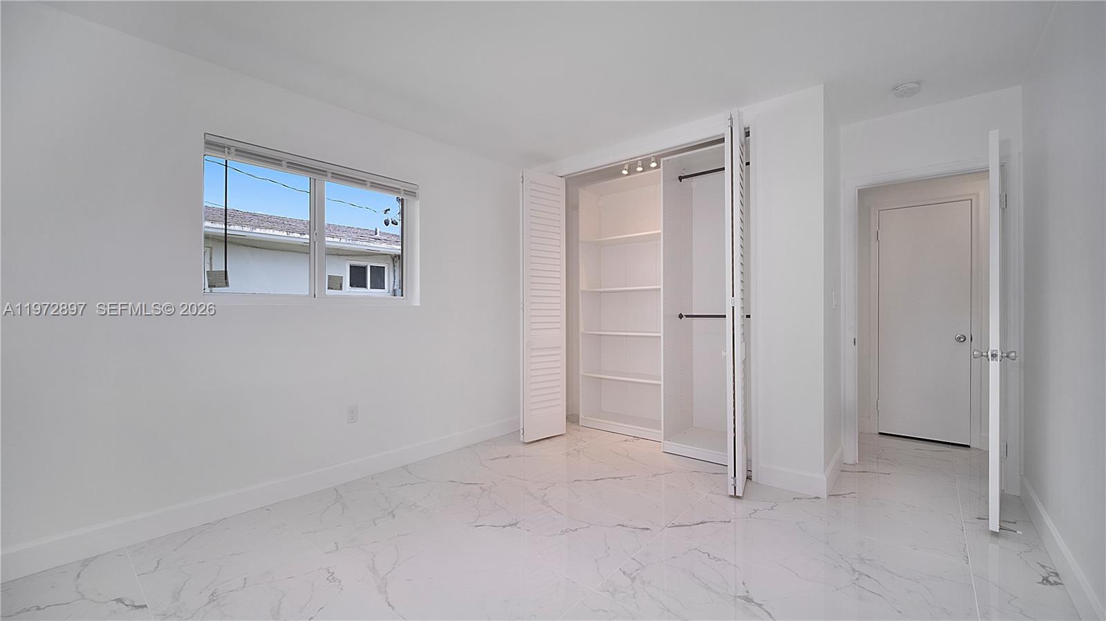 11690 Southwest 81st Road, Unit 11690 Pinecrest, FL 33156 - Photo 22 of 26 an empty room with windows