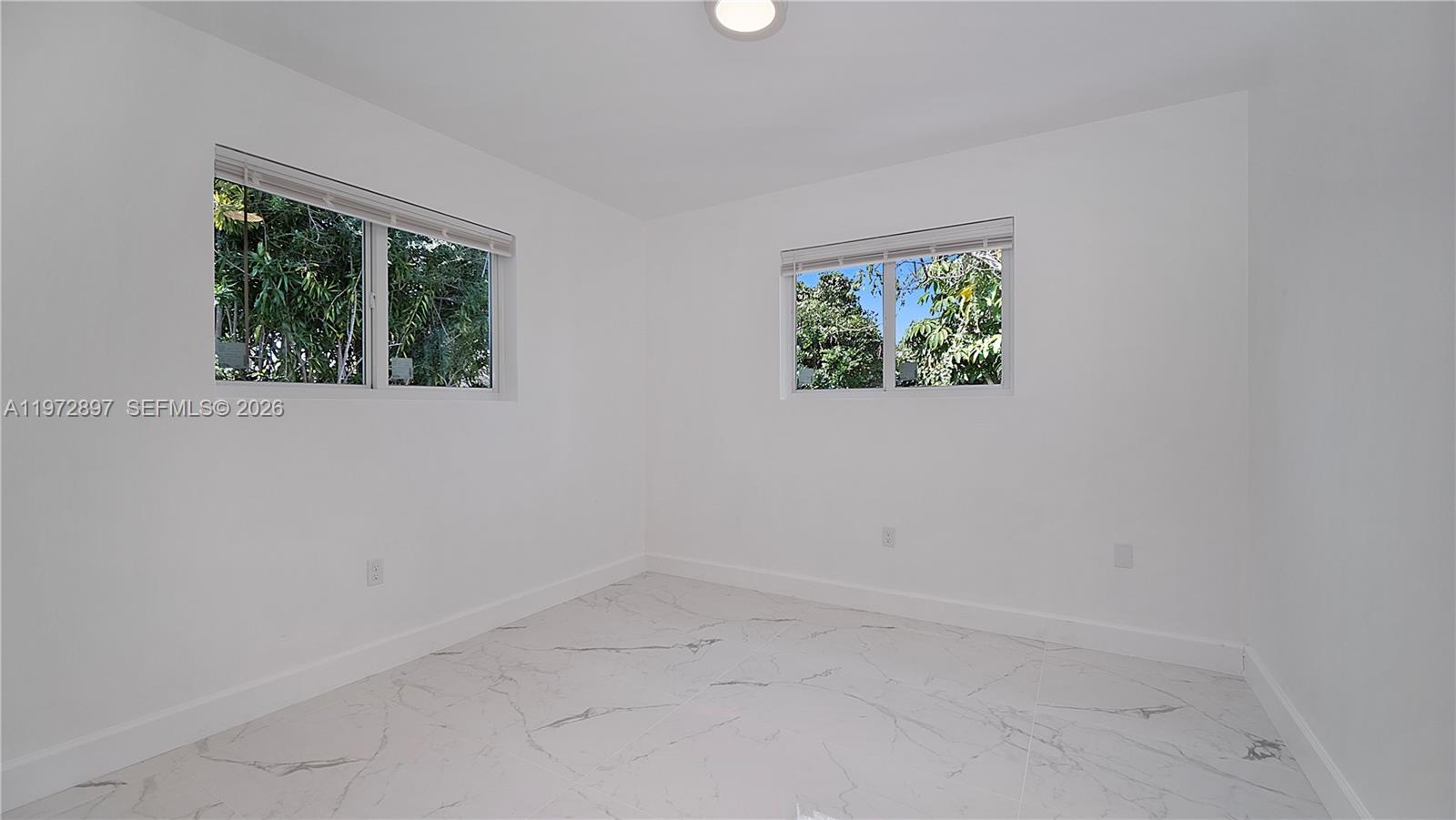 11690 Southwest 81st Road, Unit 11690 Pinecrest, FL 33156 - Photo 23 of 26 an empty room with windows