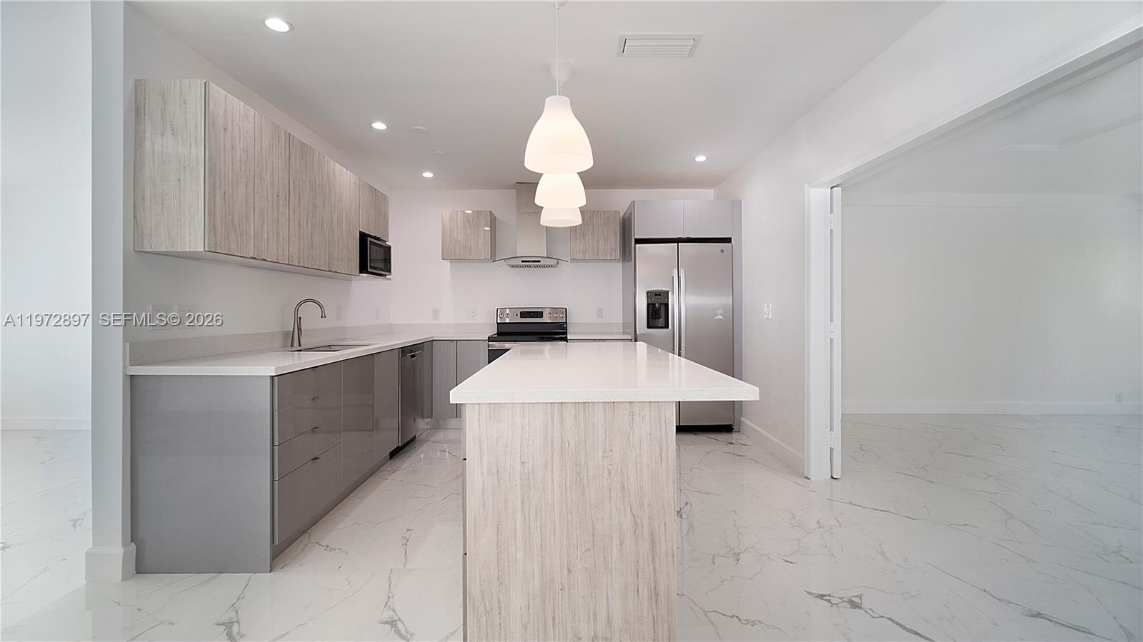11690 Southwest 81st Road, Unit 11690 Pinecrest, FL 33156 - Photo 7 of 26 a kitchen with kitchen island a sink stainless steel appliances and cabinets