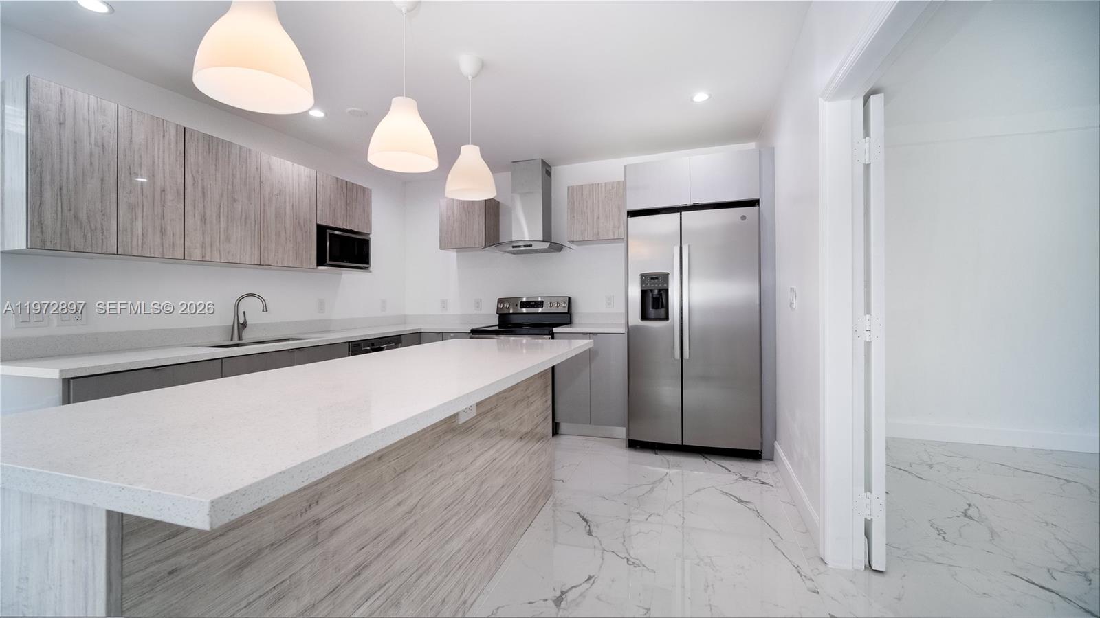 11690 Southwest 81st Road, Unit 11690 Pinecrest, FL 33156 - Photo 8 of 26 a large kitchen with cabinets and stainless steel appliances