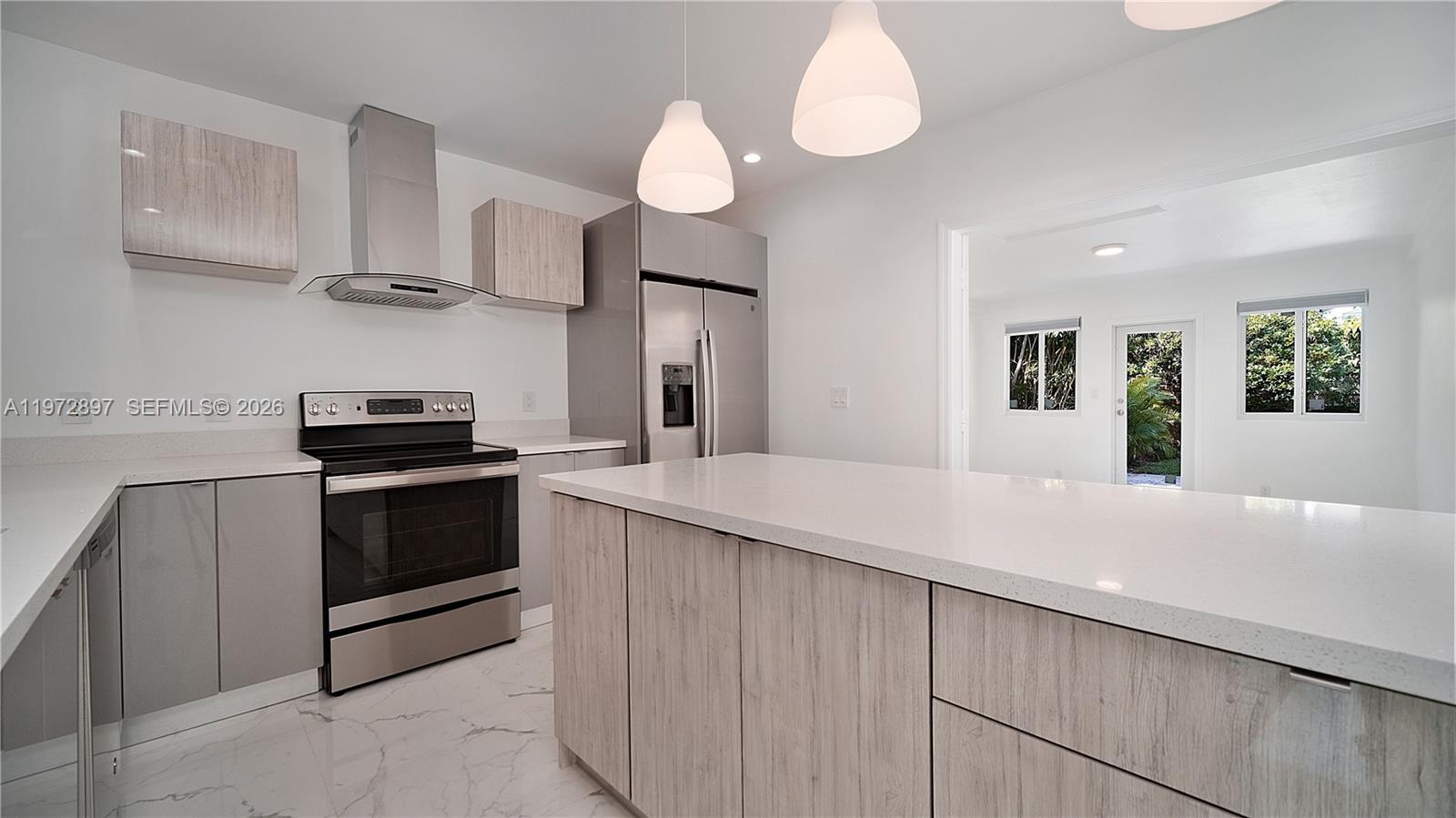 11690 Southwest 81st Road, Unit 11690 Pinecrest, FL 33156 - Photo 9 of 26 a kitchen with cabinets and stainless steel appliances