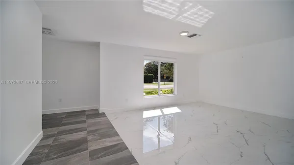 a view of room with window and hardwood floor