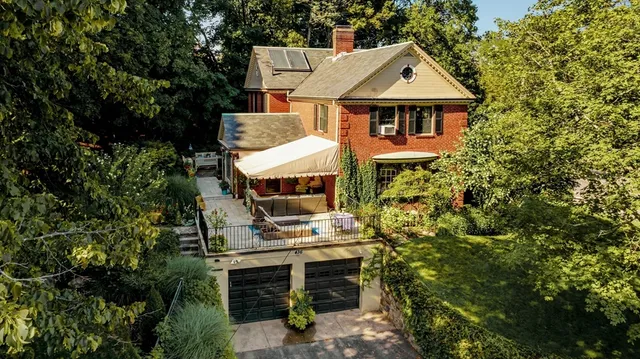 an aerial view of a house with a yard and balcony