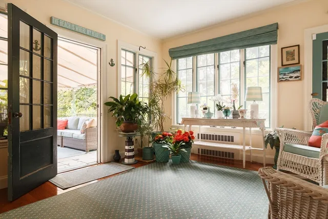 a bedroom with furniture and a large window