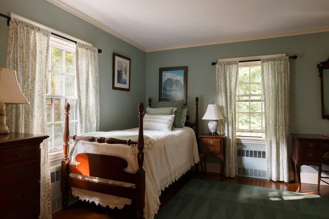 a bedroom with a bed chair and a window