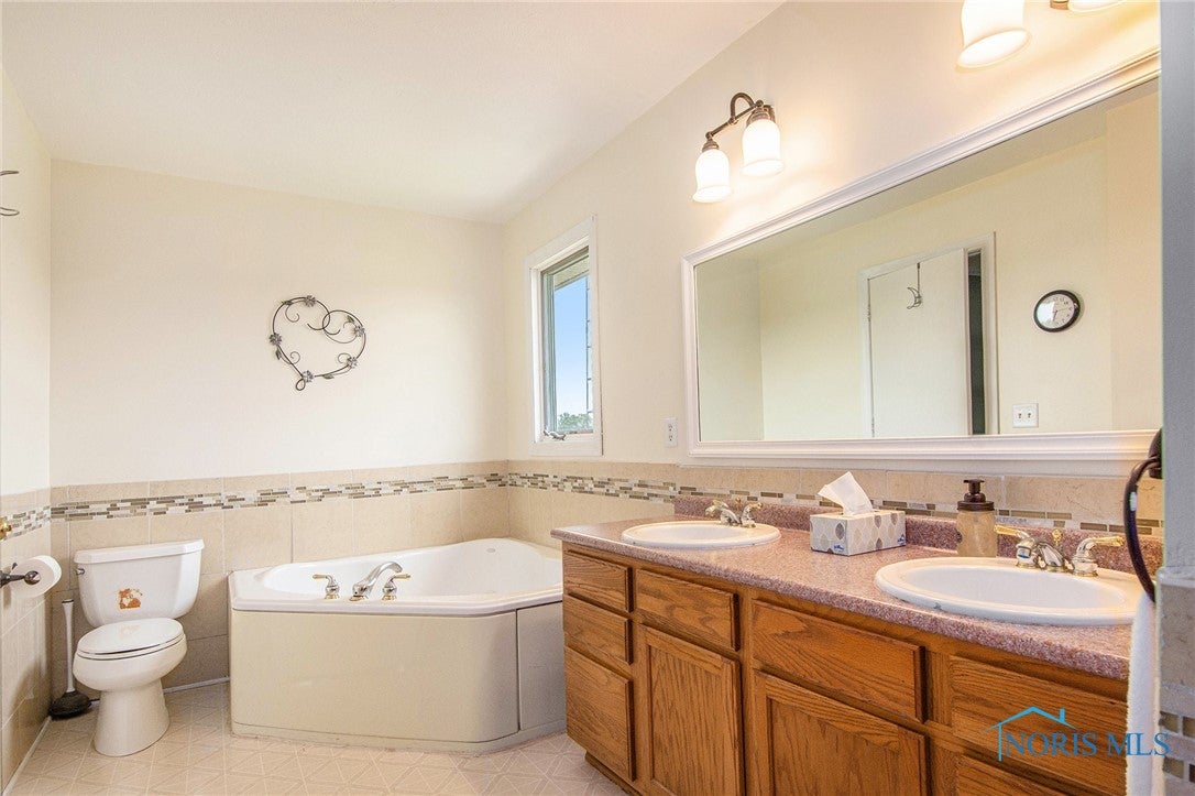 4052 County Road South Edon, OH 43518 - Photo 21 of 37 Primary Suite bathroom with separate jet tub and shower, two sink vanity with lots of storage