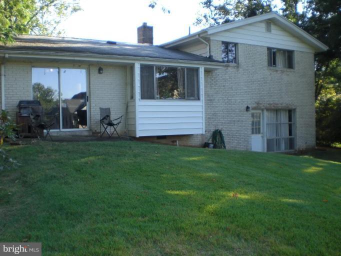 6115 Greentree Road Bethesda, MD 20817 - Photo 2 of 19 a front view of a house with a yard