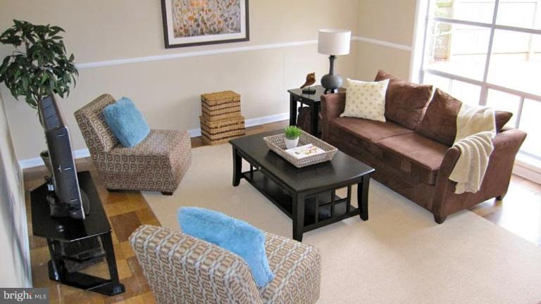 6115 Greentree Road Bethesda, MD 20817 - Photo 12 of 19 a living room with furniture and a potted plant