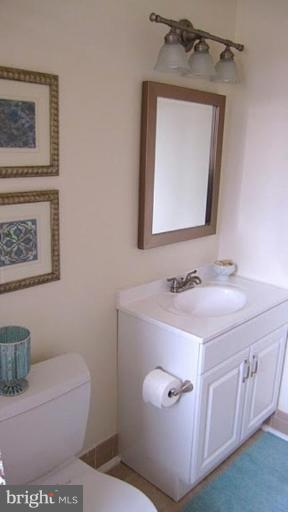 6115 Greentree Road Bethesda, MD 20817 - Photo 19 of 19 a bathroom with a sink a toilet and mirror