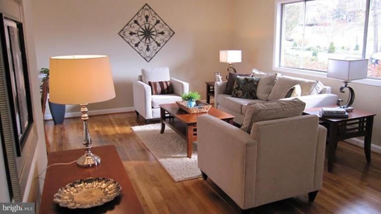 6115 Greentree Road Bethesda, MD 20817 - Photo 6 of 19 a living room with furniture and a large window